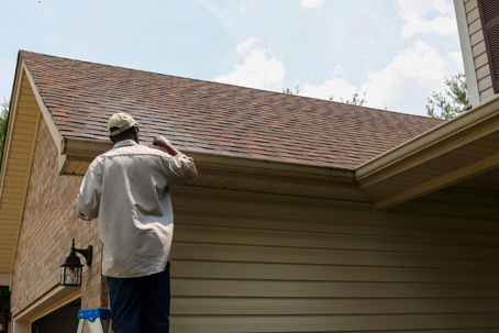 a homeowner inspecting his roof