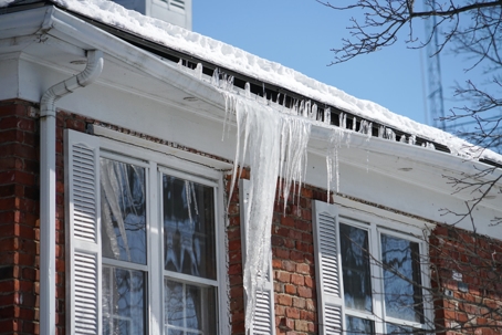 Search by image or video Icicle on the house roof in winter season